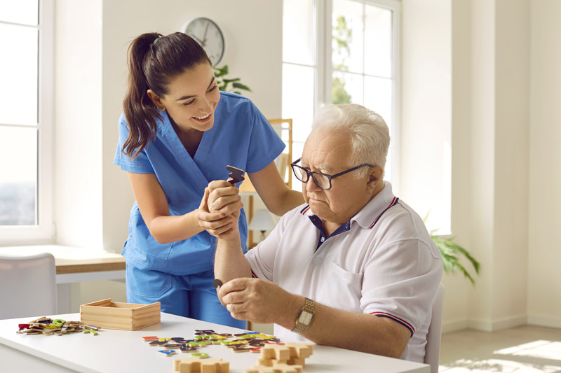 Caregiver assisting resident with activities